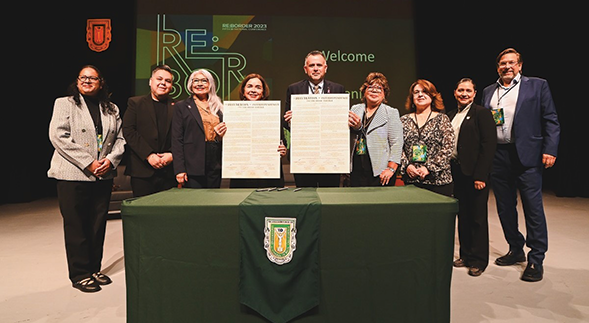 SDSU President Adela de la Torre (fourth from left) is joined by Re:Border 2023 attendees in signing a the Declaration of Interdependence at the fifth annual conference. (SDSU)